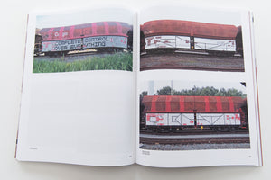 121/183 761 PHOTOS OF RED-BROWN STEEL FREIGHT WAGONS WITH A PAINTING ON THE SIDE