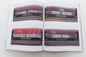 121/183 761 PHOTOS OF RED-BROWN STEEL FREIGHT WAGONS WITH A PAINTING ON THE SIDE